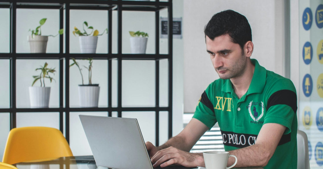Digital nomad working on a laptop in an Asian coworking cafe