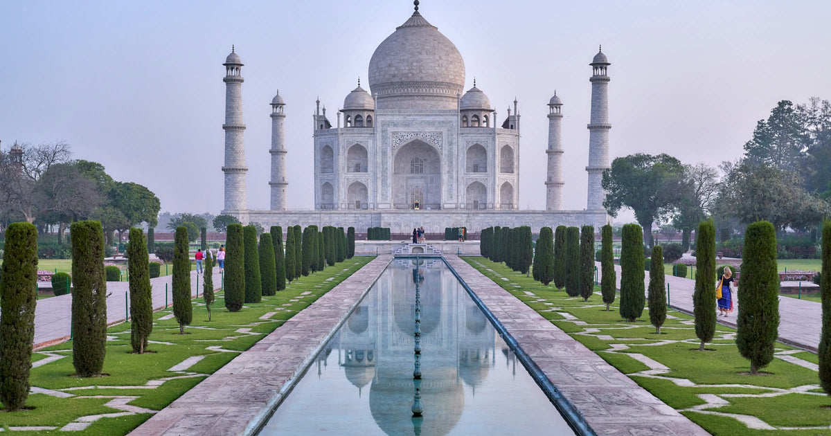 Taj Mahal reflected in the central pool at dawn, Agra India