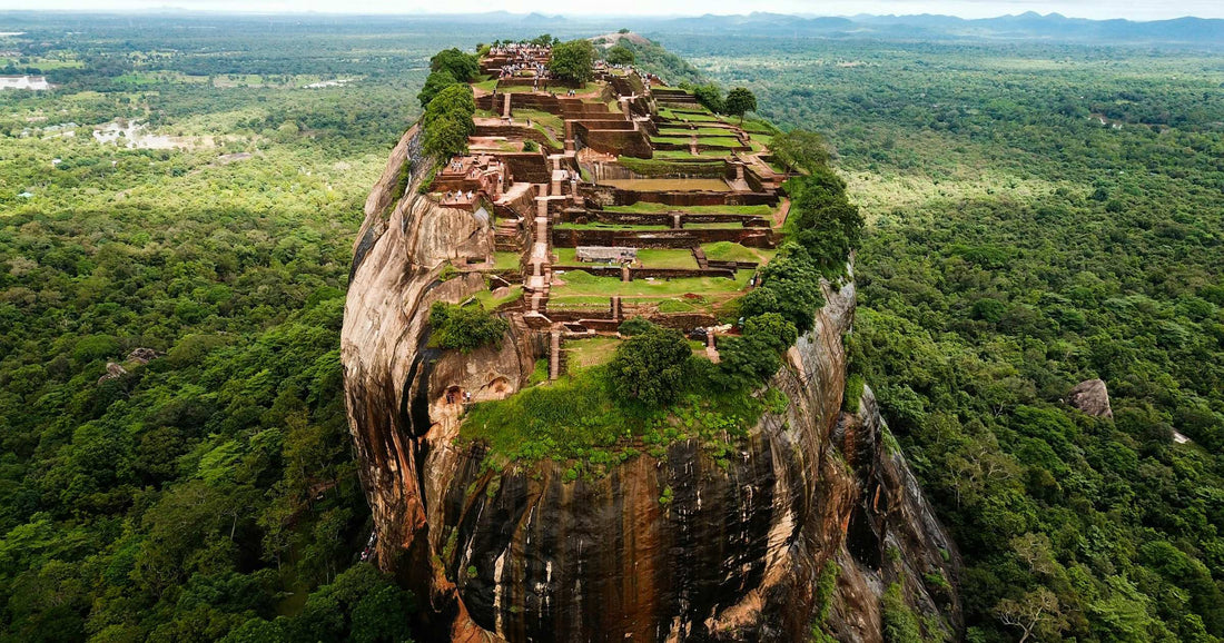 Aerial view of Sigiriya Rock Fortress and ancient palace ruins rising above the jungle in Sri Lanka