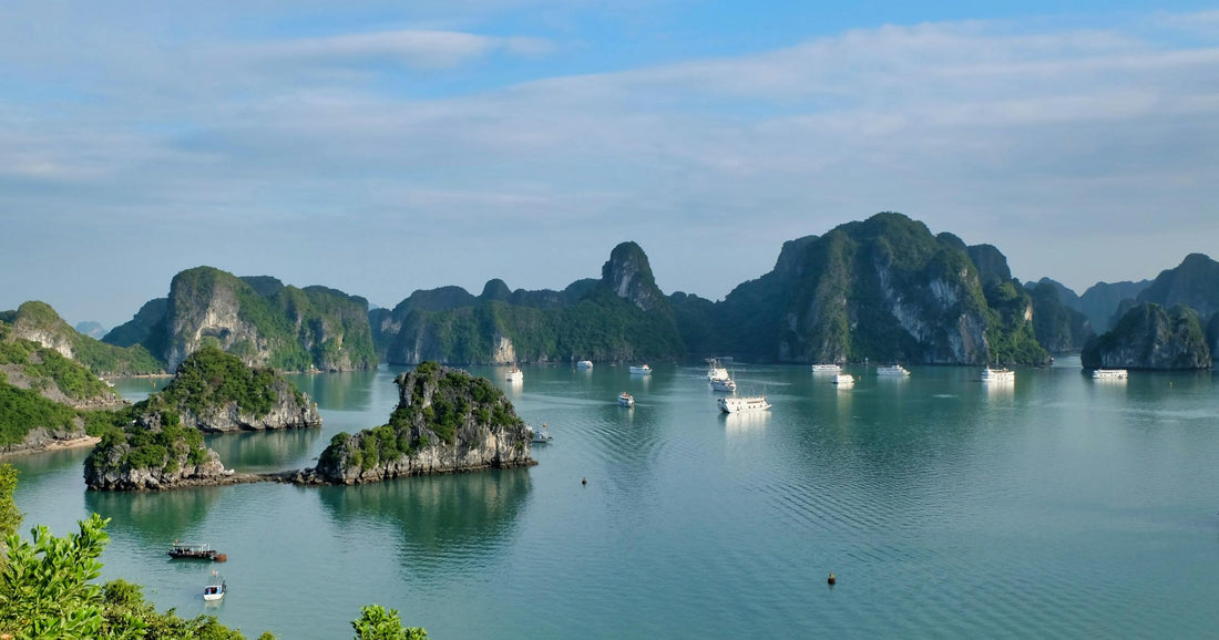 Ha Long Bay karst limestone islands and cruise boats on turquoise water in Northern Vietnam