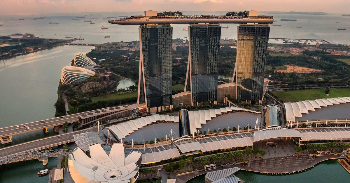 Marina Bay Sands and Singapore CBD skyline at golden hour aerial view