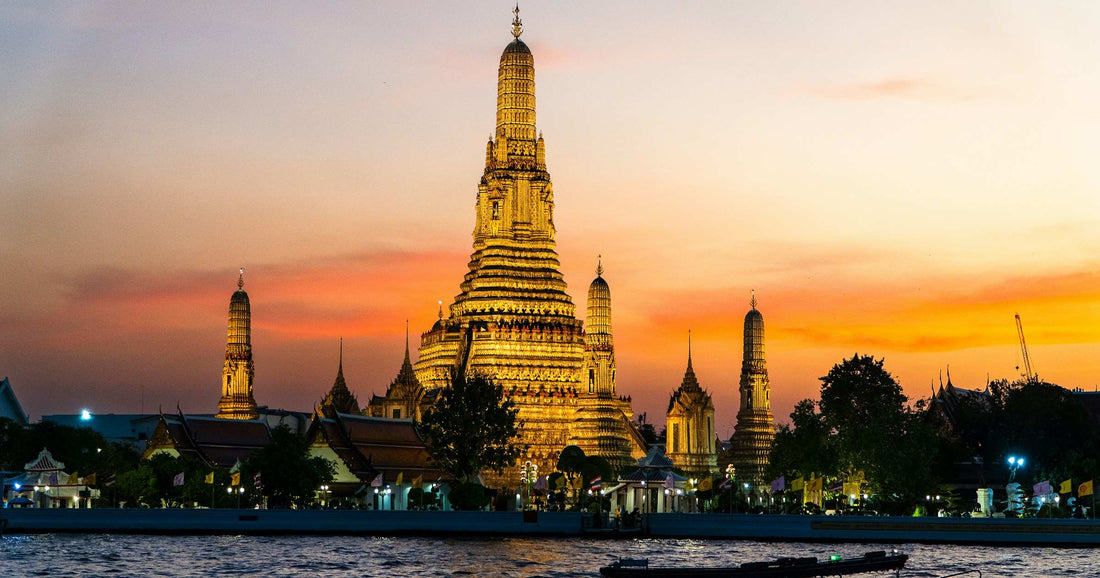 Wat Arun temple at golden-hour sunset in Bangkok, Thailand, representing Southeast Asia travel