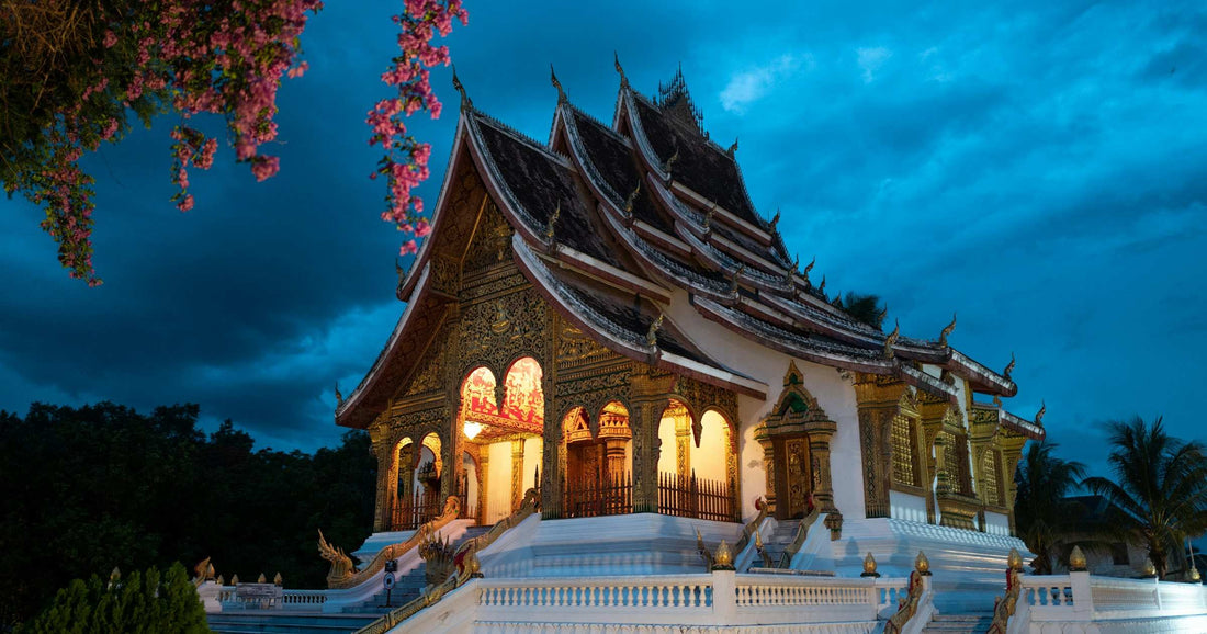 Ornate Luang Prabang temple illuminated at dusk in Laos