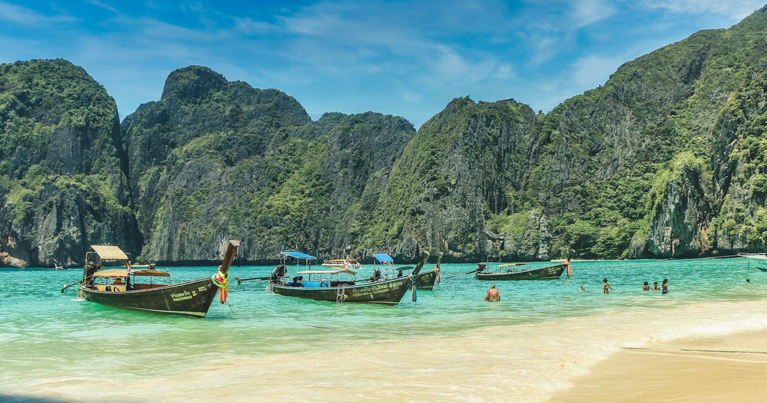 Longtail boats on turquoise water at a Thailand island beach