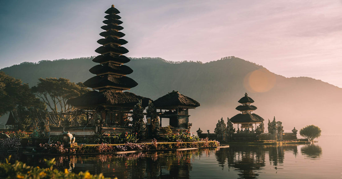 Misty tiered pagoda temple reflected in still water, Indonesia — evocative of Yogyakarta temple heritage